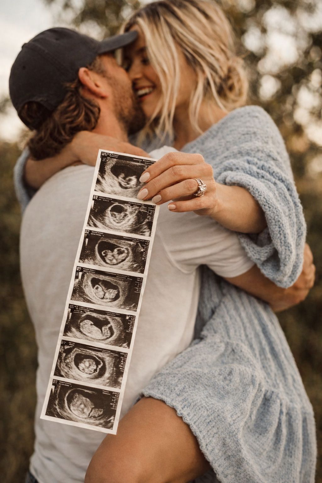 Happy couple at Agape Scan Studio holding ultrasound photos